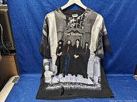 Front view of charcoal gray Beatles tee showing full-color photographic print of group and surrounding columns