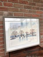 Front view of the framed print showing winter skating scene