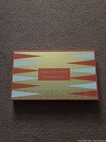 Top of the closed box showing Frank Lloyd Wright Backgammon Set design with geometric patterns in orange, beige, and blue.