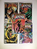 Five Marvel Comics Kazar The Savage issues arranged on a flat surface showing cover art and plastic sleeves.