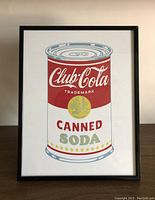 Full view of framed Club-Cola Canned Soda pop art print showing red, white, and gold can design on flat surface.
