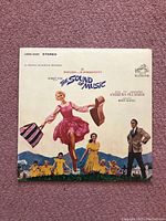 Front cover of The Sound of Music vinyl LP album featuring Julie Andrews artwork and title text.