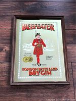 Full view of the framed vintage Beefeater London Distilled Dry Gin advertising mirror with the Yeoman Warder image and text.