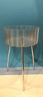 Vintage IKEA Hatten Sidobord plant stand front view showing metal legs and scalloped metal top frame.