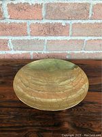 Top view showing the engraved radial pattern and petal-like shapes on the interior of the brass bowl.