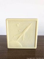 Square plastic case with raised rocket and planet design embossed with 'CCCP' text.