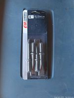Photo of the sealed blister pack showing all four air chisel tools from Campbell Hausfeld, front view.