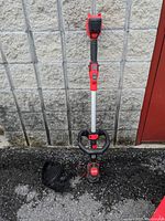 Full view of the Craftsman V20 string trimmer and edger handheld unit showing condition and included guard attachment.