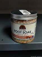 Front view of the jar showing label with brand Okay Foot Spa, product Foot Soak Detox Salt Himalayan Pink Salt with Lavender & Tea Tree Oil, 20 oz net weight.