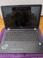 Front open view of HP laptop with black keyboard and Intel Core i5 sticker on palm rest