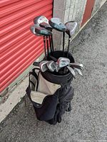 Full view of 14 golf clubs with heads visible in Wilson cart bag, showing club varieties and bag condition.