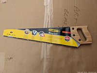 Front side view of Stanley 20 inch Rough Cut Sharp Tooth Saw with label showing product features