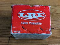 Top view of original red and white box labeled LRE Stereo Preamplifier model 99-0139 with signs of wear on edges.