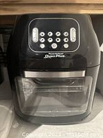 Front view of PowerAirFryer Oven Plus digital air fryer with control buttons and glass door