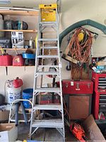 8-foot aluminum step ladder fully extended with yellow top tool tray in garage setting