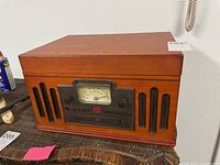 Full view of Crosley wooden media player with vintage style radio and speaker grille