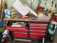 Full view of red 9-drawer tool chest with wood top