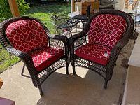 Both wicker chairs side by side on patio with cushions installed
