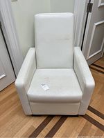 Front view of white Monte glider chair showing stains on seat and backrest cushions.