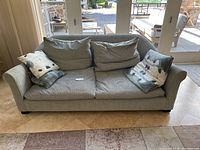 Front view of the gray Montauk deep seat sofa with cushions, showing condition and fabric details.