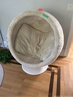 Front view of white faux fur egg chair showing plush seat cushion and chair shell