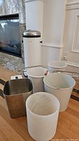 Wide view of all items included: step-on trash can, three white waste bins, a metal organizer, and tissue cover
