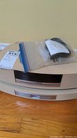 Stacked beige Bose Wave main unit and multi-CD changer with sealed bag of cable on top