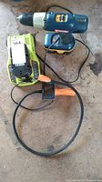 Photo showing Ryobi cordless drill, charger with spare battery, and Bresser inspection camera coiled cable and handle.