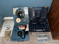 Overview of Black & Decker drill in original case with polishing and wire wheels, Mastercraft tap and die set in plastic case, and instruction manuals.