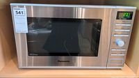 Front view of Panasonic microwave oven showing stainless steel and control panel with digital display.