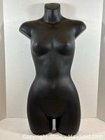 Front view of the black female mannequin torso showing detailed anatomical shaping and matte finish.