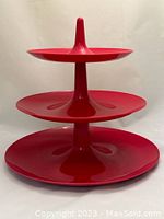 Front view of the assembled 3-tier raspberry red serving stand with all pieces stacked.