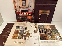 Six Sothebys auction catalogues arranged for display, showing covers with furniture and decorative art images