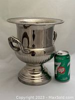 Vintage silver plated champagne bucket next to a soda can to show scale. The bucket has two scrolled handles and a beaded rim, polished silver finish.