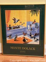 Full view of framed poster showing ducks in bathroom with gold metal frame and green matte with gold text.