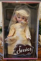 Front view of the 1976 Uneeda Jessica bride wedding doll in original box showing the doll dressed in cream wedding gown and bonnet with the name Jessica on the window.