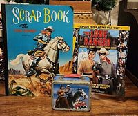 Scrapbook, mini lunch box, and magazine with Lone Ranger theme displayed together
