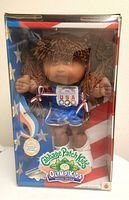 Photo of Cabbage Patch Kids Olympikids special edition doll in original box with USA Olympic team design and branding.