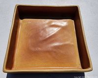 Top view of the square dish showing the brown glaze and crazing on the interior