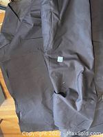 Photo showing heavy brown canvas fabric with some folds and wrinkles.