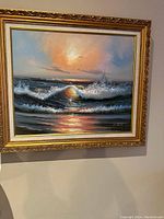 Full view of the framed vintage oil painting depicting a dramatic seascape at sunset with waves and seagulls, signed by H. Gailey.