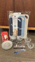 Photo showing all items including cutting boards in packaging, glass cups, dessert plates, spoon, and grape shears