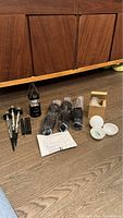 Three sets of garden solar stakes, two glow balls, handheld Toyota light, instruction sheet, and several small accessories laid out on wooden floor.