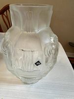 Overall view of frosted glass vase with visible Desna sticker and figural reliefs on the sides.