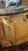 Photo of the comforter set inside its plastic packaging showing floral fabric and attached label