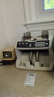 Money counting machine and electric pencil sharpener on a table
