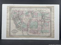 Full frontal view of antique map mounted on foam board and shrink-wrapped, showing all six states with colored borders and geographical features