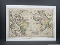Full view of hand-coloured antique map showing South America and Africa with Atlantic Ocean, mounted on foam board and shrink-wrapped.