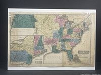 Full view of the antique hand-coloured map showing the United States with various states and territories marked in different colours.