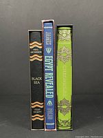 Spine view showing Black Sea by Neal Ascherson, Egypt Revealed by T.G.H. James, Chronicles by R. Holinshed, all Folio Society editions.
